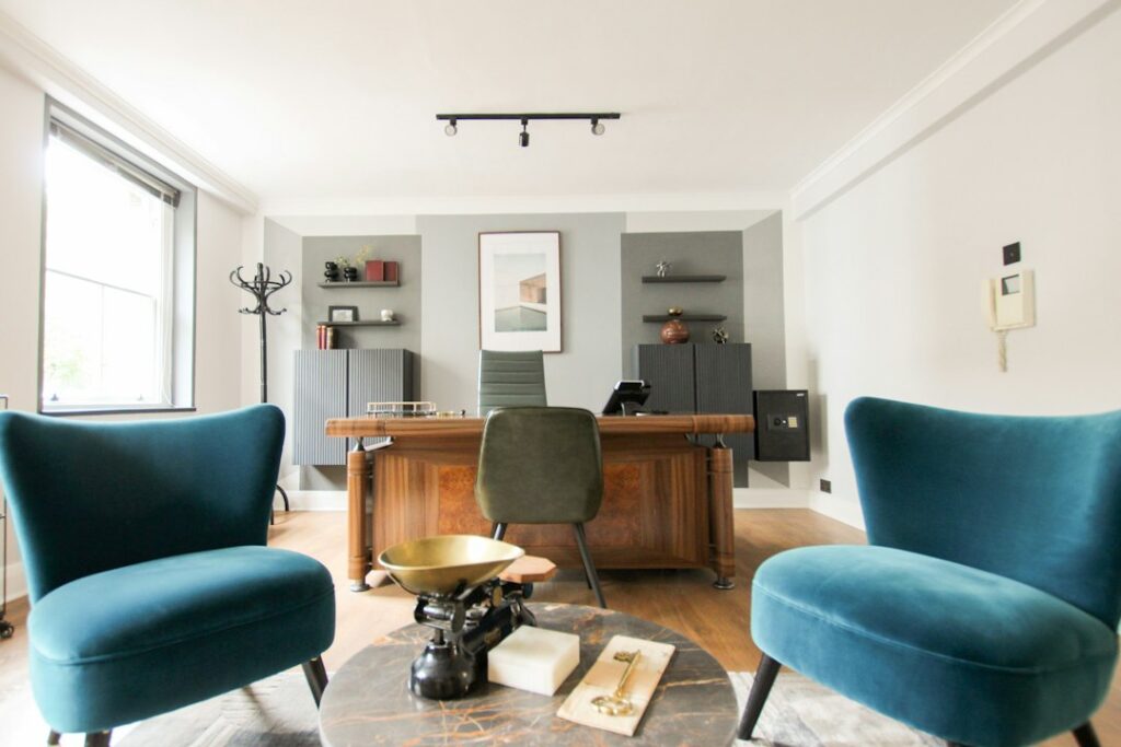 black and brown wooden table near blue padded chair in a peaceful counseling office